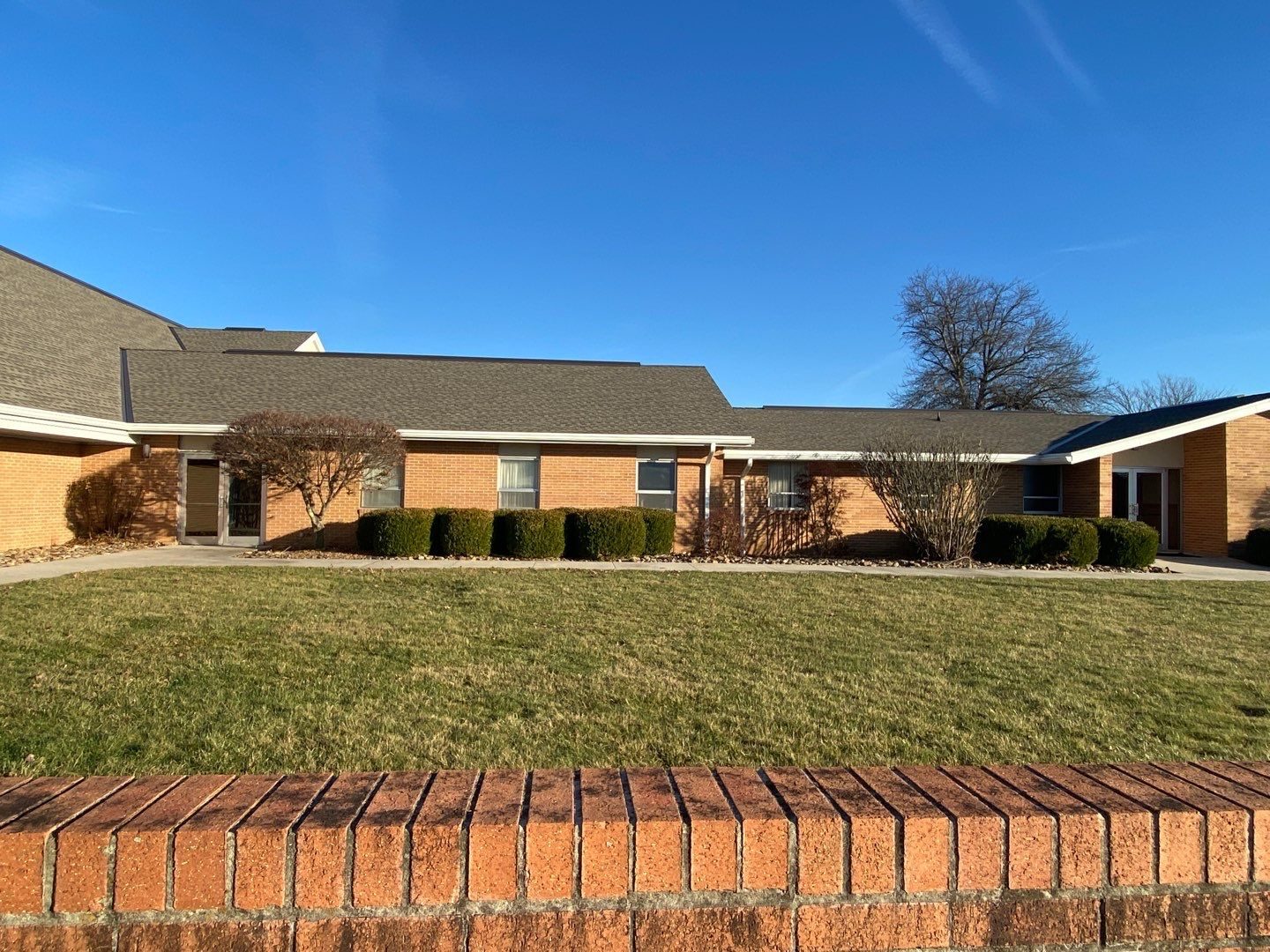Shingle roofing on a single-story brick commercial building in Crossville, TN by McGuire Roofing
