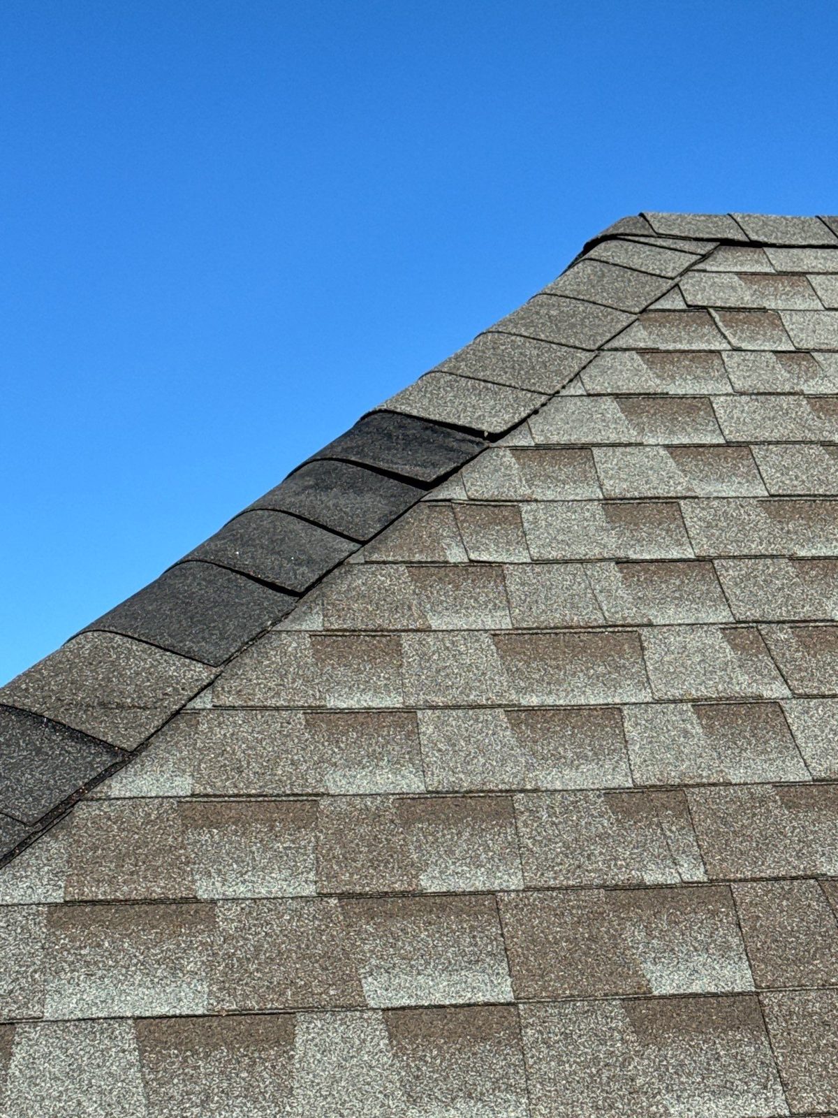 Close-up of architectural shingles along a roof ridge in Kingston, TN by McGuire Roofing