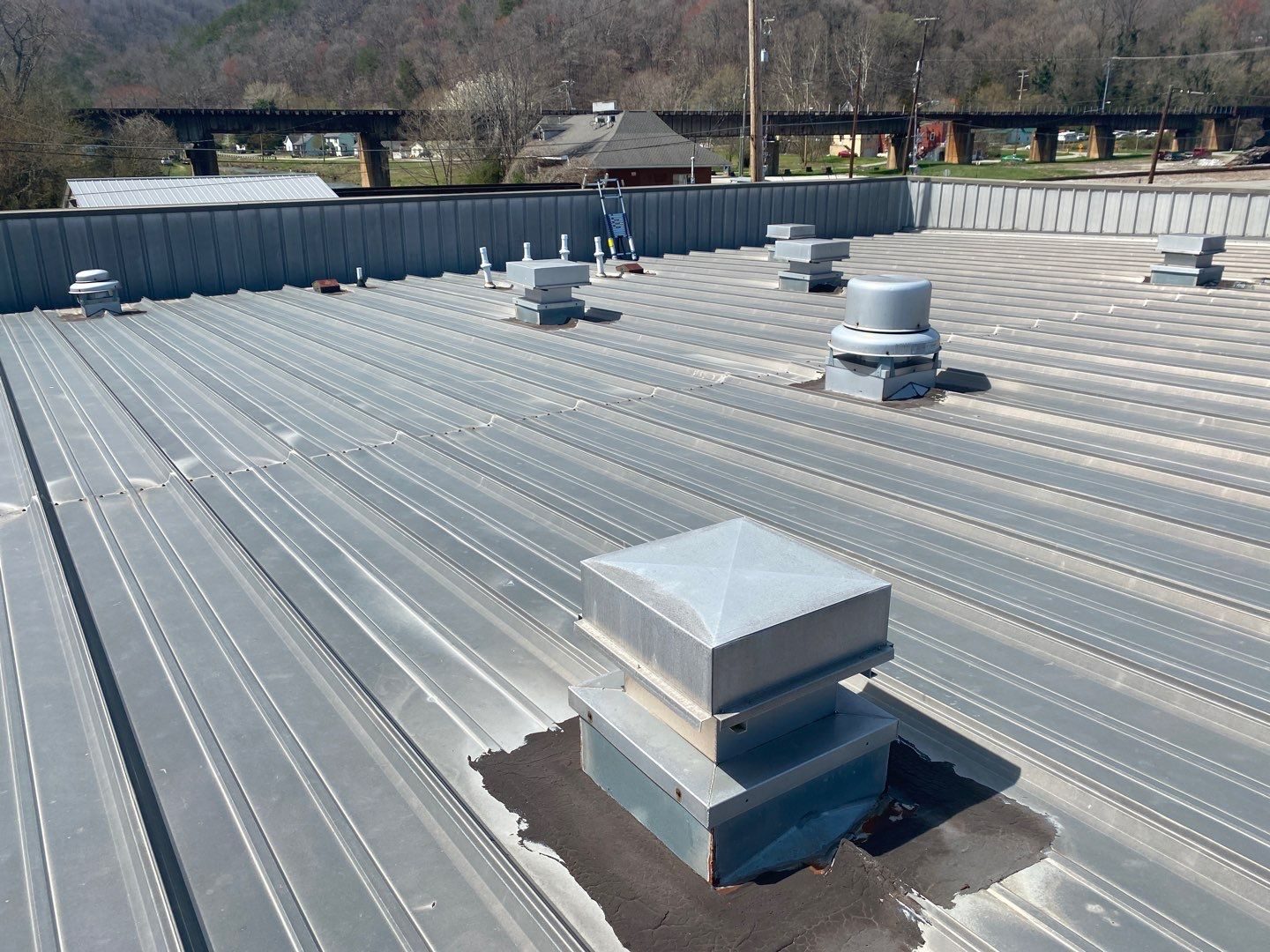 Standing seam metal roof with vents on a commercial building in Rocky Top, TN by McGuire Roofing