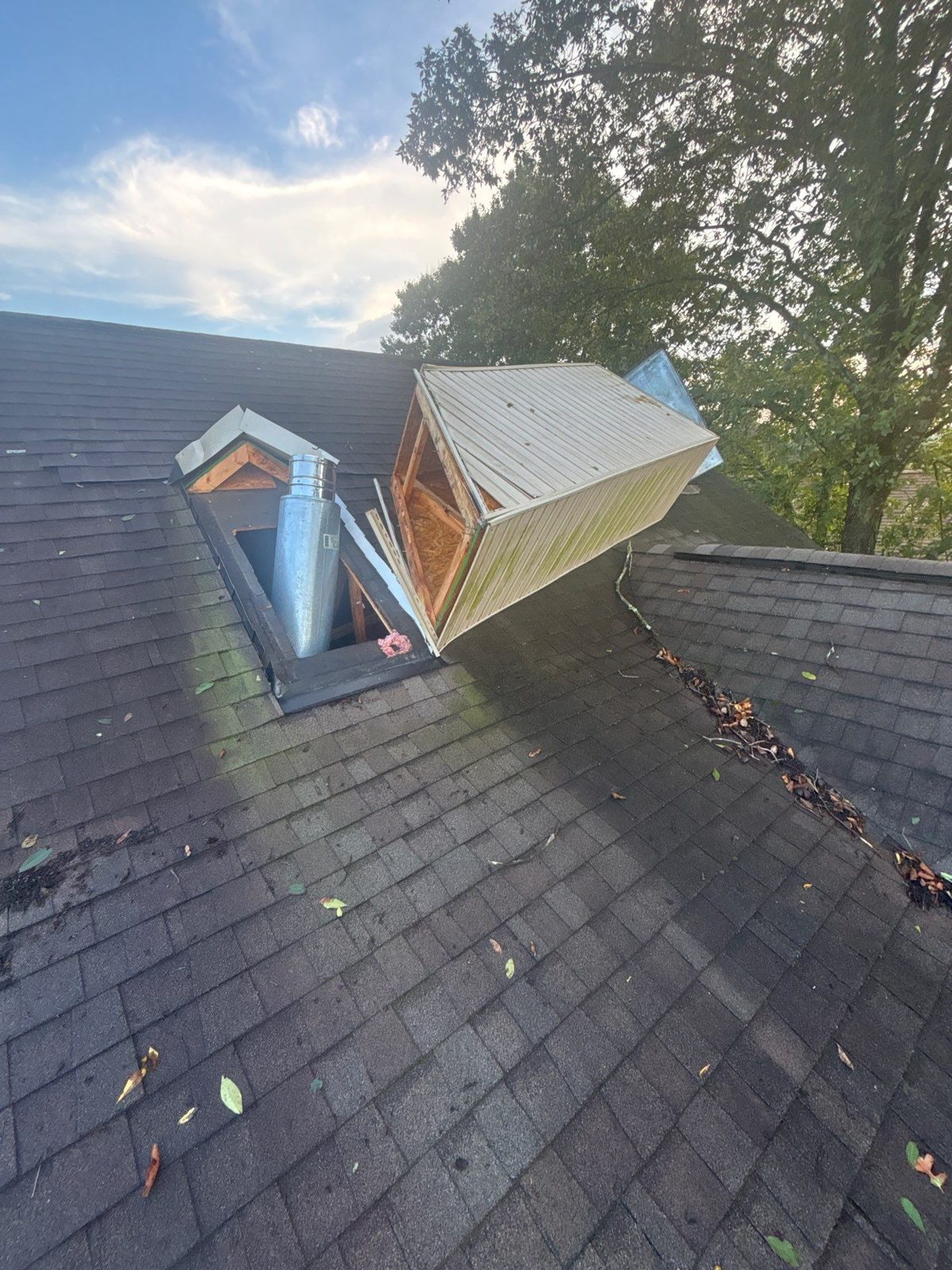 Wind storm damage with a chimney chase blown over on a shingle roof in Tellico Village, Loudon, TN